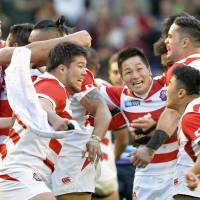 The Brave Blossoms celebrate after their victory over South Africa during the 2015 Rugby World Cup | KYODO