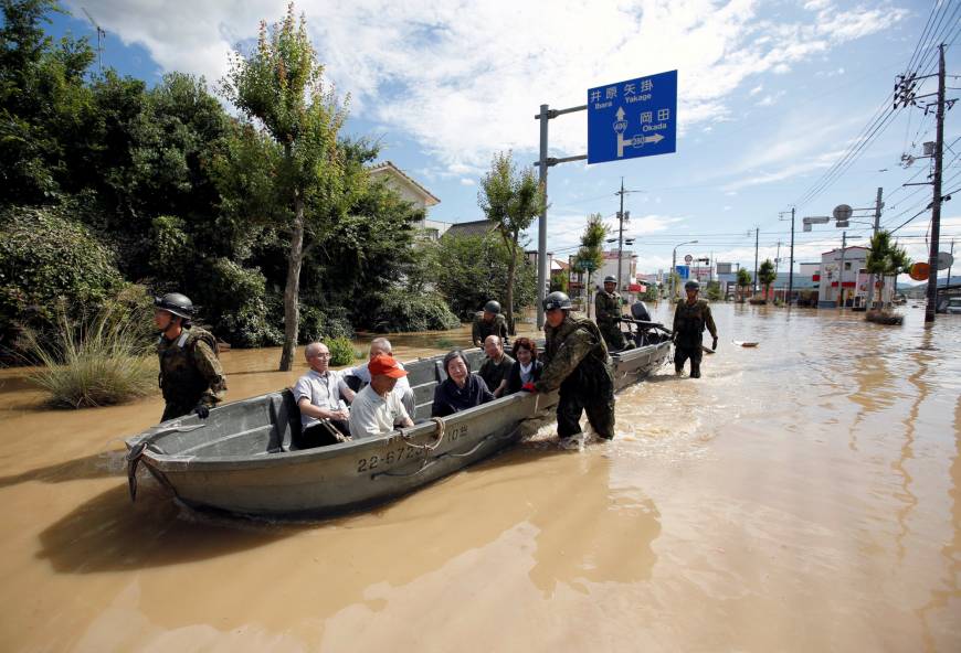 Self-Defense Force soldiers rescue people from a flooded area of Kurashiki, Okayama Prefecture, on Sunday.