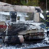 Firefighters work at a destroyed German high speed ICE train after it caught fire on the way from Cologne to Frankfurt in Dierdorf, Germany, on Friday. | REUTERS