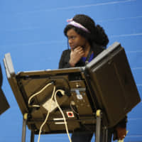 A voter waits for assistance from a volunteer at the Tuttle Park Recreation Center in Columbus, Ohio, on Tuesday. | AP
