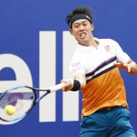 Kei Nishikori hits a return to Taylor Fritz in the second round of the Barcelona Open on Tuesday. Nishikori won 7-5, 6-2. | KYODO
