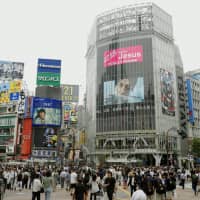 Tokyo\'s Shibuya scramble crossing was the site of a March prank in which a group placed a bed with a YouTuber on top in the middle of the intersection as pedestrians traversed it. | KYODO