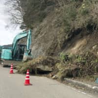 A slope is collapsed along a road in Wajima, Ishikawa Prefecture, on Friday morning after the city was hit by a quake registering an upper 5 out of 7 on the Japanese earthquake intensity scale earlier in the day. | KYODO