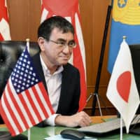 Defense Minister Taro Kono attends a videoconference with his American and Australian counterparts at the ministry Wednesday. | DEFENSE MINISTRY / VIA KYODO