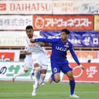 Kofu\'s Dudu (right) and Niigata\'s Gonzalo Gonzalez vie for the ball during a match on June 27 at Yamanashi Chuo Bank Stadium in Yamanashi Prefecture. | VENTFORET KOFU / KYODO
