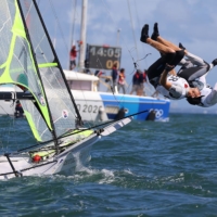 Germany\'s Erik Heil and Thomas Ploessel jump into the water as they celebrate winning bronze for the men\'s 49er sailing competition | REUTERS