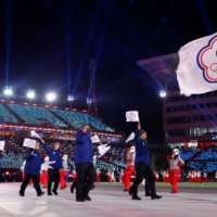 Te-An Lien of Taiwan carries the national flag during the opening ceremony of the Pyeongchang Winter Olympics in February 2018. | REUTERS