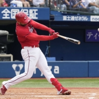 Hiroshima\'s Ryan McBroom hits his 16th home run of the season against the BayStars in Yokohama on Saturday. | KYODO