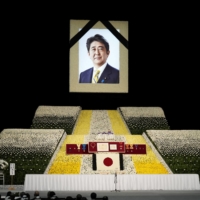 The stage at the state funeral of former Prime Minister Shinzo Abe at the Budokan in Tokyo on Sept. 27. The assassination of Abe on July 8 while giving a campaign speech in the city of Nara shocked the nation and the world, and continues to reverberate politically. | POOL / VIA REUTERS