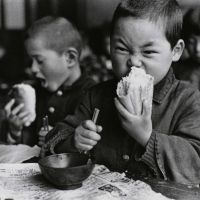 \"Munching on a roll, from First Grade\" (1953)by Genichi ) Kumagai. | THE TOKYO METROPOLITAN MUSEUM OF PHOTOGRAPHY