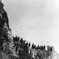 Mass confusion: Japanese troops cheer and wave flags after breaching the walls of Nanjing, the former Chinese capital, to capture the city on Dec. 14, 1937. | AP PHOTO