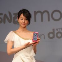 Smart move: Actress Maki Horikita displays an NTT DoCoMo Inc. Disney smartphone at a news conference Wednesday. The new gadget hits the market later this month. | KAZUAKI NAGATA