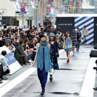 De rigeur denim: Models wearing clothing made of denim walk along an outdoor runway on the main street in the upmarket Ginza shopping district in Tokyo on Saturday. | MINORU MATSUTANI
