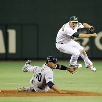 Double trouble: A\'s shortstop Cliff Pennington throws to complete a fifth-inning double play as the Mariners\' Miguel Olivo slides on Tuesday. Seattle defeated Oakland 3-1 in 11 innings. | AP