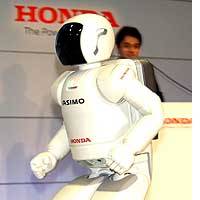 A new version of Honda Motor Co.\'s ASIMO humanoid robot \"jogs\" during a media preview at the automaker\'s research and development center in Wako, Saitama Prefecture. The robot can now go 3 kph. | HIROKO NAKATA PHOTO