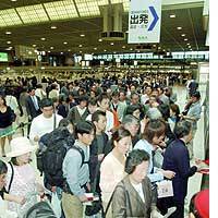 Travelers wait to depart Wednesday from Narita airport in Chiba Prefecture. | AKEMI NAKAMURA PHOTO