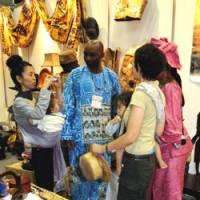 Trade fair: Visitors check out clothing and other goods at African Fair 2008 in the Pacifico Yokohama convention center Wednesday in Yokohama. The fair, which runs through Sunday, is exhibiting goods from 41 African countries. | SATOKO KAWSAKI PHOTO