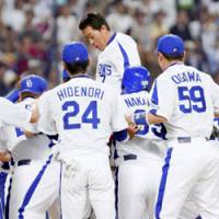 Man of the hour: The Chunichi Dragons celebrate with Lee Byung Kyu (top center) after his 10th inning home run of Hanshin\'s Kyuji Fujikawa gave the Dragons a 3-2 victory on Saturday in Nagoya. | KYODO PHOTO
