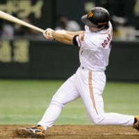 Potent swing: Giants slugger Michihiro Ogasawara bashes a three-run home run in the eighth inning against the BayStars on Thursday. Yomiuri defeated Yokohama 7-3. | KYODO PHOTO