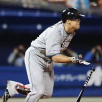 Double or nothing: Fighters pinch hitter Sho Nakata hits a double during a five-run seventh inning against the BayStars in Yokohama on Friday. The visitors won 7-1. | KYODO PHOTO