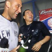 Bit of the bubbly: Hideki Matsui celebrates with Yankees teammate Derek Jeter after their team\'s 4-1 victory over the Minnesota Twins. The Yanks will be advancing to their first AL championship series since 2004. | KYODO PHOTO