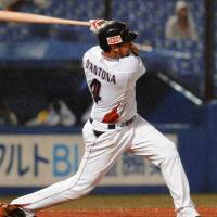 Jamie D\'Antona of the Swallows belts a two-run homer in the fourth inning of Monday\'s game against the Hokkaido Nippon Ham Fighters at Jingu Stadium. Tokyo Yakult won 6-0. | KYODO PHOTO