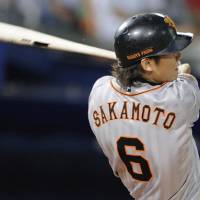 Yomiuri Giants shortstop Hayato Sakamoto connects for a two-run double in the eighth inning of Friday\'s game against the BayStars at Yokohama Stadium. | KYODO PHOTOS