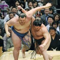 Another one bites the dust: Hakuho sends Baruto on his way at the Spring Grand Sumo Tournament in Osaka on Sunday. | KYODO PHOTO