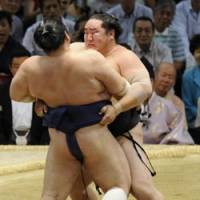 Out you go: Yokozuna Asashoryu manhandles ozeki Kotomitsuki during 12th day of the Nagoya Grand Sumo Tournament. | KYODO PHOTO