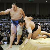 Power game: Kotooshu (right) edges out Baruto in the Kyushu Grand Sumo Tournament on Wednesday in Fukuoka. | KYODO PHOTO
