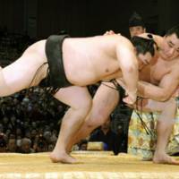 Falling fast: Harumafuji sends Asashoryu to his first loss of the Kyushu Grand Sumo Tournament on Thursday in Fukuoka. | KYODO PHOTO