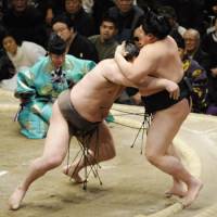 Show of force: Yokozuna Hakuho (left) overpowers Hokutoriki on Friday during the New Year Grand Sumo Tournament. Hakuho is the only remaining unbeaten wrestler in the 15-day tournament. | KYODO PHOTO