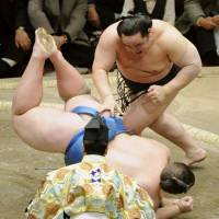 No challenge: Asashoryu throws Baruto to the dirt surface during the New Year Grand Sumo Tournament. | KYODO PHOTO