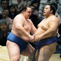 Gathering momentum: Baruto sends Kaio out of the ring at the Spring Grand Sumo Tournament on Monday. | KYODO PHOTO