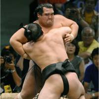 Mr. Perfect: Harumafuji (front) pushes Kotoshogiku out of the ring at the Nagoya Grand Sumo Tournament on Monday. KYODO PHOTO | KYODO