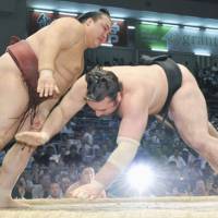 Too close for comfort: Kisenosato (left) and rival Kotooshu square off on the 12th day of the Nagoya Grand Sumo Tournament. Kisenosato defeated Kotooshu. | KYODO PHOTO