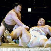 Sheer force: Hakuho (left) defeats Baruto on Saturday in the Autumn Grand Sumo Tournament at Ryogoku Kokugikan. | KYODO PHOTO