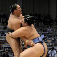 In control: Kotoshogiku (right) defeats Kyokutenho at the Kyushu Grand Sumo Tournament on Tuesday in Fukuoka. | KYODO