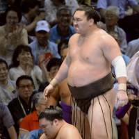 Avenged: Hakuho stands over Goeido after beating him at the Nagoya Grand Sumo Tournament on Monday. | KYODO