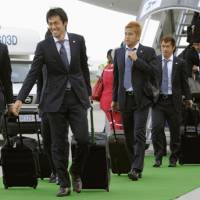 Down to business: Members of Japan\'s World Cup squad disembark at George, South Africa, ahead of their opening first-round game with Cameroon on June 15. | KYODO PHOTO