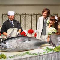 Till death do us part: A chef prepares to cut a bluefin tuna as models posing as newlyweds look on at the Royal Pines Hotel in Wakayama in October. | COURTESY OF ROYAL PINES HOTEL