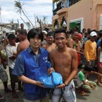 Under the radar: A member of the International Children\'s Action Network (ICAN) delivers aid to residents in the town of Dulag on typhoon-hit Leyte Island. | COURTESY OF ICAN