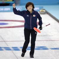 Still in the hunt: Japan skip Ayumi Ogasawara celebrates after her final throw helped her team beat China 8-5 at the Sochi Olympics on Monday. | AP