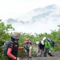 Climbers head for the summit of 1,729-meter-high Mount Daisen in Tottori Prefecture in June. | KYODO