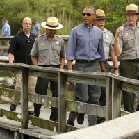 U.S. President Barack Obama takes a walking tour of the Anhinga Trail at Everglades National Park, Florida, Wednesday. Obama is visiting the subtropical swamps as part of a push to get Americans thinking and talking about the damage climate change is causing close to home. | REUTERS
