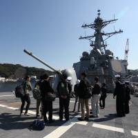 Journalists tour the destroyer USS Benfold in Yokosuka, Kanagawa Prefecture, on Monday. The ship\'s deployment to the region is part of Washington\'s refocusing on Asia. | ALASTAIR WANKLYN