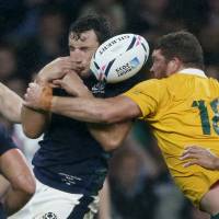 John Hardie of Scotland is tackled by Greg Holmes of Australia before a late penalty was awarded to Australia during their Rugby World Cup Quarter Final at Twickenham in London on Sunday. | REUTERS