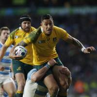 Australia\'s Israel Folau is tackled during the Wallabies\' Rugby World Cup semifinal win over Argentina at Twickenham in London on Sunday. | AFP-JIJI