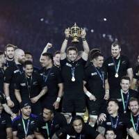 New Zealand captain Richie McCaw lifts the Webb Ellis trophy after the All Blacks beat Australia 34-17 to win the Rugby World Cup in London on Saturday. New Zealand became the first team to retain the trophy, and also the first to win it three times. | REUTERS