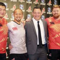 (From left) Shinnosuke Kakinaga, Yuki Yatomi, Mark Hammett, Edward Quirk pose for pictures during a news conference on Monday in Tokyo. | KAZ NAGATSUKA